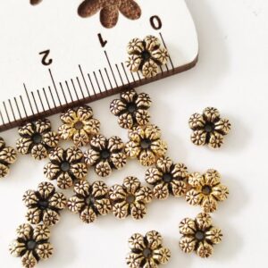 Separador em metal " flor"- dourado-7 mm